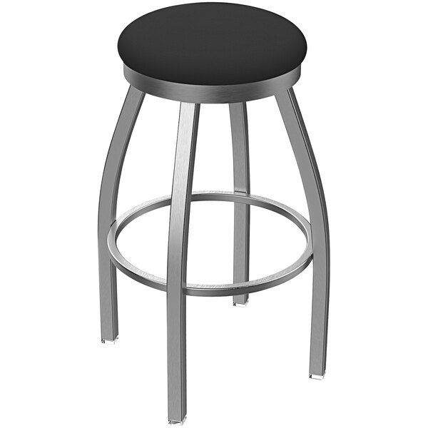 A black Holland Bar Stool outdoor swivel bar stool with silver legs and a black seat.