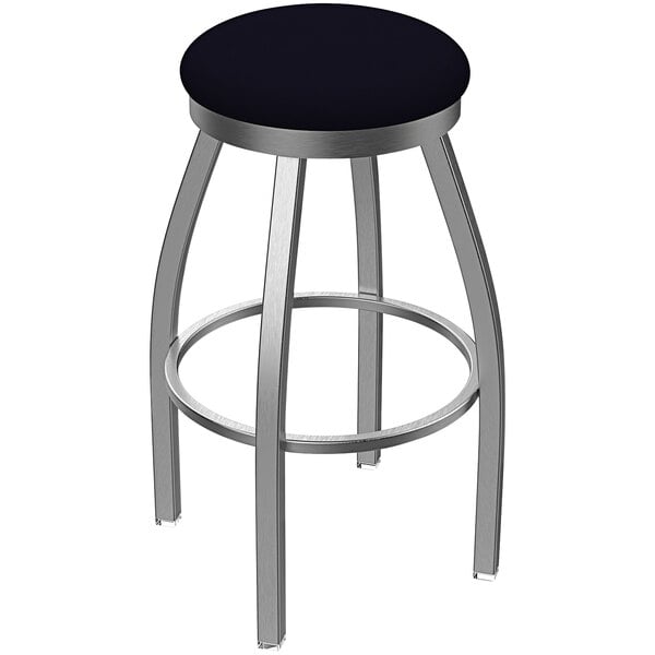 A Holland Bar Stool stainless steel outdoor counter stool with a Breeze Sapphire seat and a swivel base.