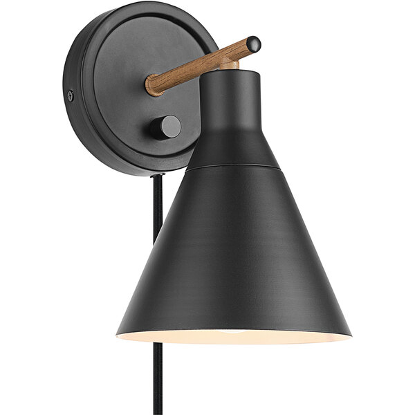 A matte black wall sconce with a faux walnut detail and black shade.