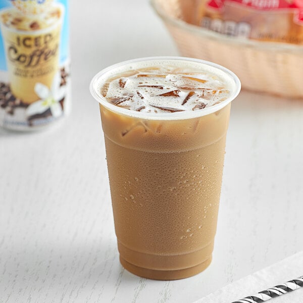 A close-up of a cup of International Delight Vanilla Iced Coffee with ice in it.