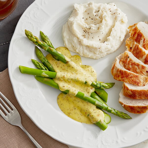 A plate of food with Lawry's Salt-Free 17 Seasoning mashed potatoes, asparagus, and chicken.