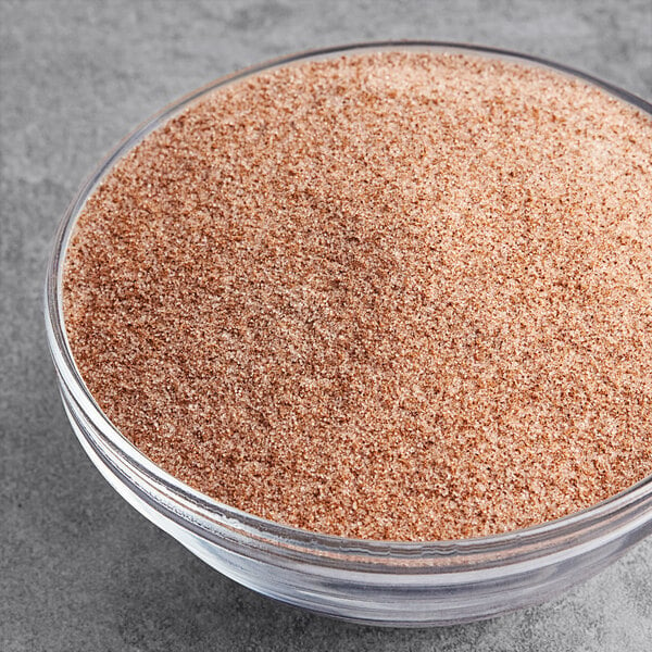 A bowl of brown powder with McCormick Culinary Cinnamon Sugar in it.
