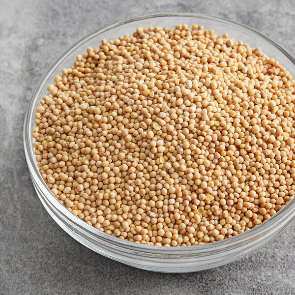 A bowl of McCormick yellow mustard seeds.