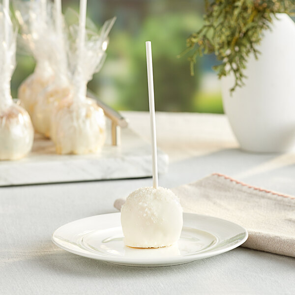 A white plate with white Chalet Desserts Italian Cream cake pops on it.