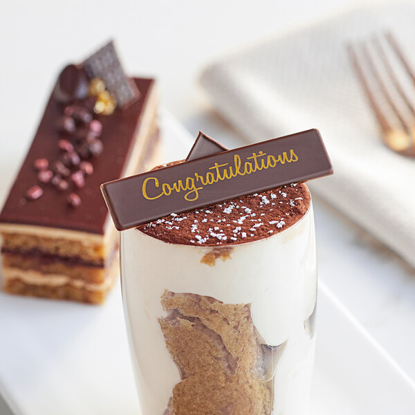 A chocolate dessert with a "Congratulations" chocolate sign on top.