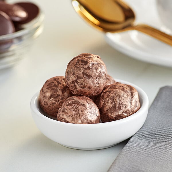 A bowl of brown chocolate balls.