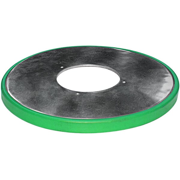 A circular metal object with a green rim.
