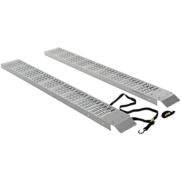 A pair of metal loading ramps with a metal grate surface.
