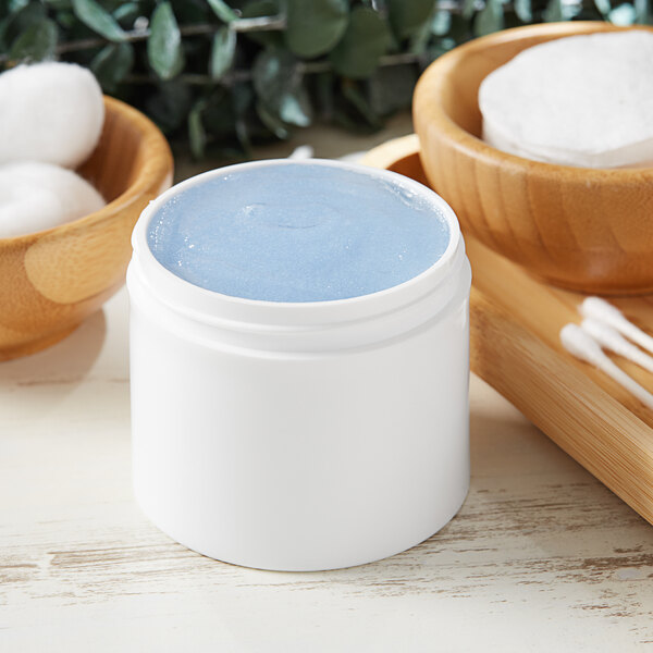 A white customizable jar filled with blue liquid.