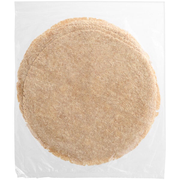 A clear plastic bag filled with thin round brown tortillas.