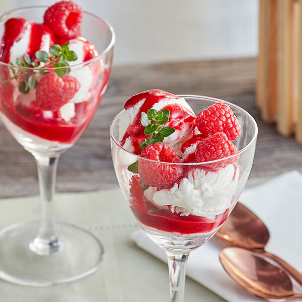 Two glasses of ice cream with Perfect Puree Red Raspberry puree and raspberries.