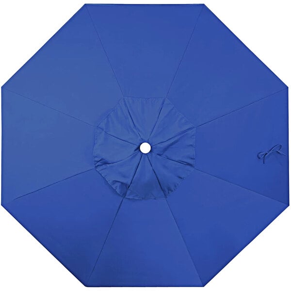 A blue California Umbrella replacement canopy with a hole in the center.