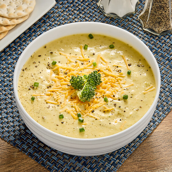A bowl of Chef Francisco broccoli and cheese soup with cheese and broccoli.
