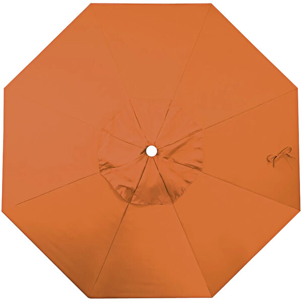 An orange umbrella with a hole in the middle.