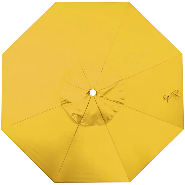 A yellow canopy for a California Umbrella with a white circle in the middle.