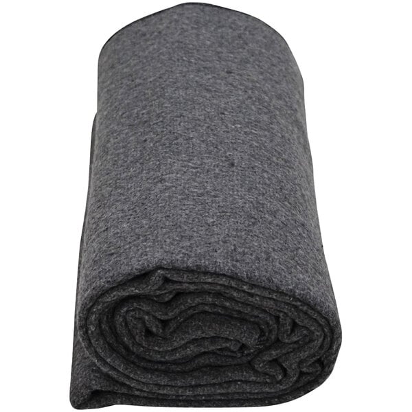 A rolled up grey Kemp USA wool blanket.