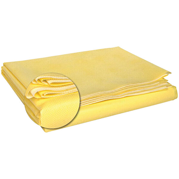 A close-up of a yellow folded Kemp USA emergency blanket.