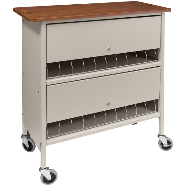An Omnimed beige medical cart with locking doors, drawers, and a cherry wood top.