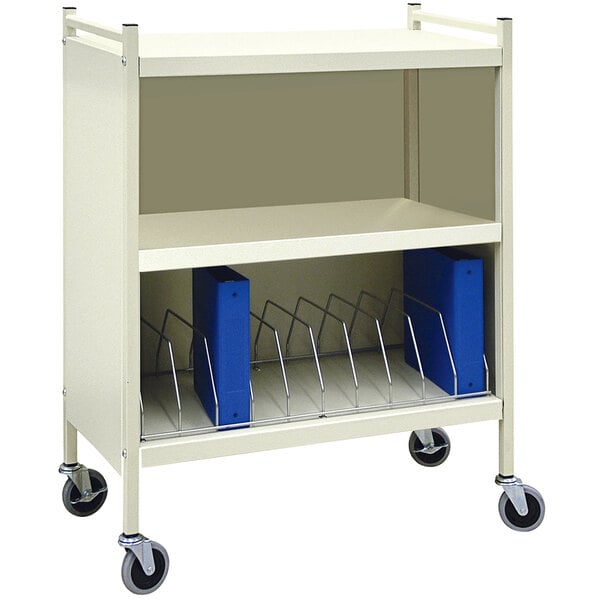 An Omnimed beige metal cart with blue binders on it.