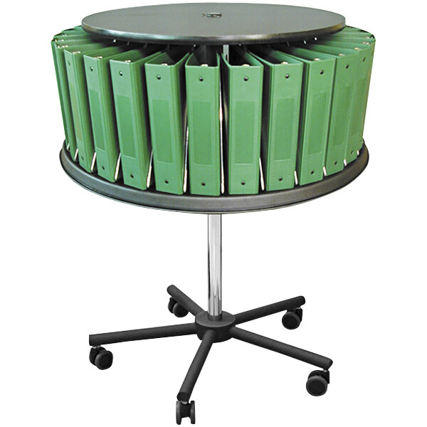A round black table with a green Omnimed 30-Binder Mobile Carousel on it.