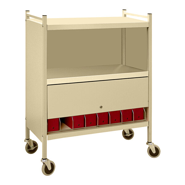 A beige Omnimed cart with locking doors and red binders on shelves.