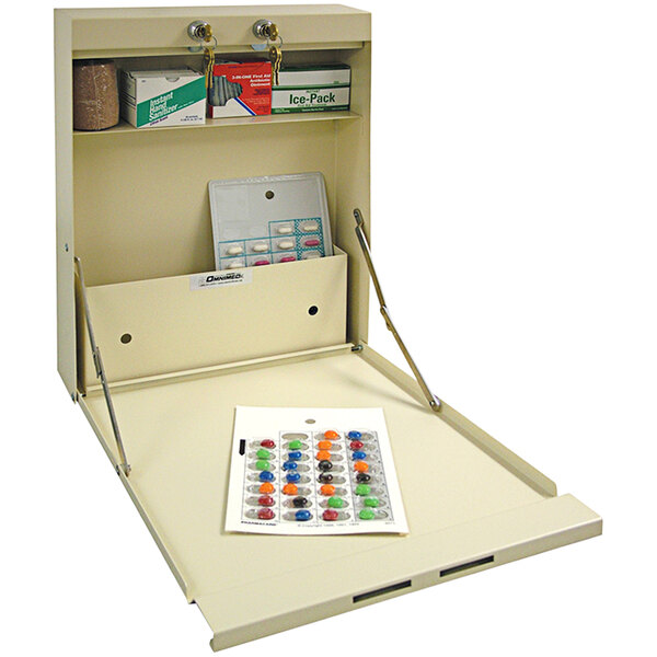 A beige Omnimed medication distribution cabinet with a white box of pills inside.
