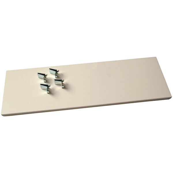 A white rectangular shelf with metal clips.