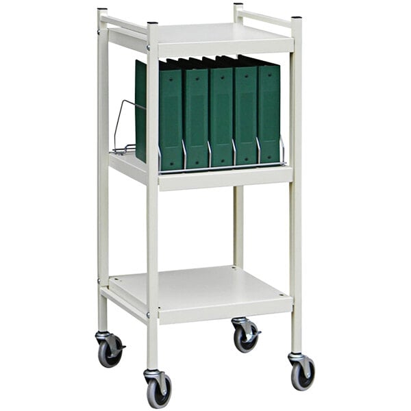 An Omnimed beige metal cart with green binders on it.