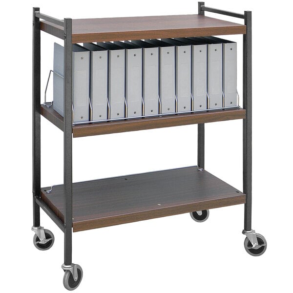 An Omnimed woodgrain medical cart with binders on a shelf.
