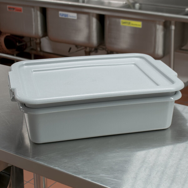 A white plastic Vollrath Flatware Soak System container with a lid on a table.