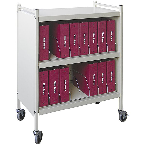 A beige Omnimed medical cart with red binders on it.