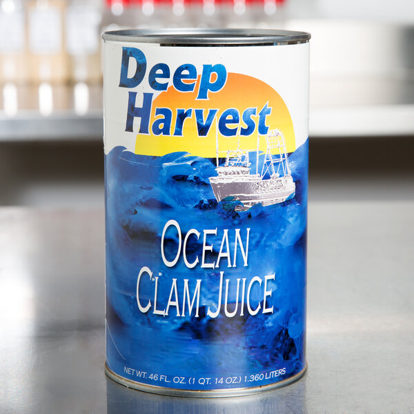 A case of Deep Harvest Ocean Clam Juice cans on a table.