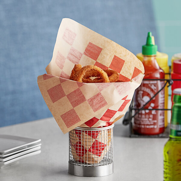 A Choice red checkered cone basket liner with onion rings inside.