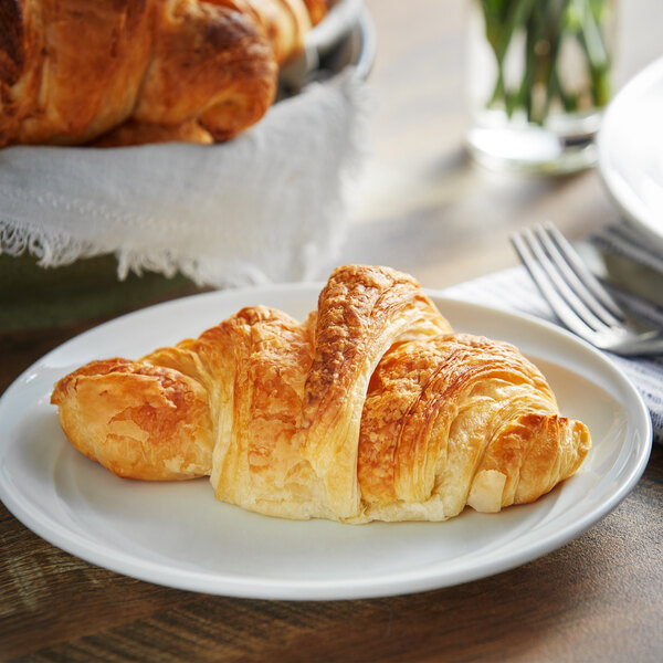 LeCoq Cuisine croissant dough sheets baked into croissants on a white plate.