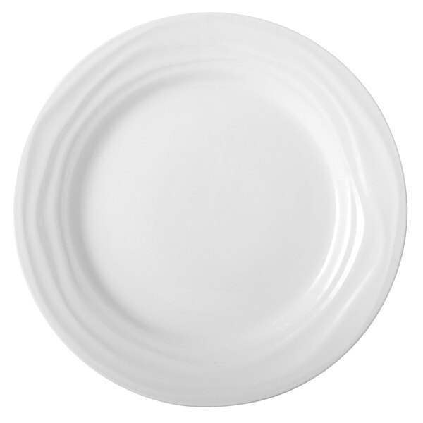 A close-up of a Tuxton TuxTrendz Sandbar bright white china plate with a wavy edge.