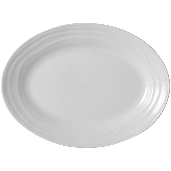 A white oval Tuxton china platter with a curved edge.