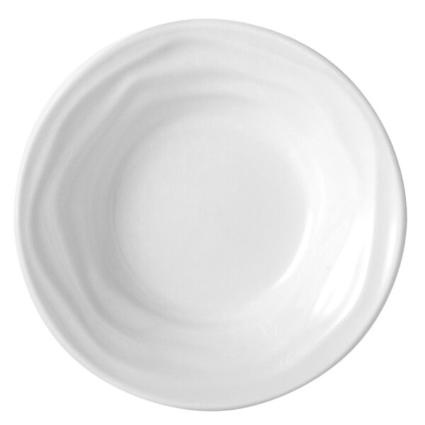 A Tuxton bright white china bowl with a wavy edge.