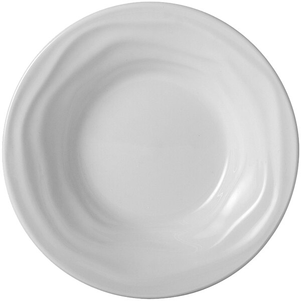 A Tuxton bright white china bowl with wavy lines on the rim.