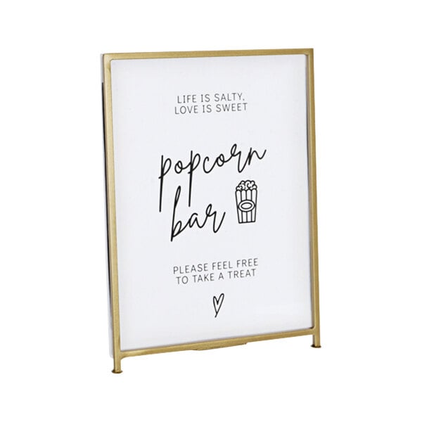 A Cal-Mil gold frame displayette with the words "popcorn bar" on it.