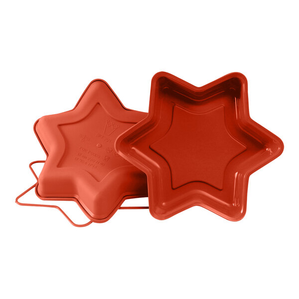 A red star shaped silicone baking mold with a lid.