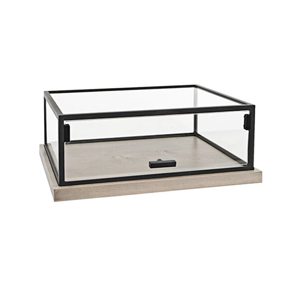 A glass box with a black metal frame and a black handle on a wooden base.