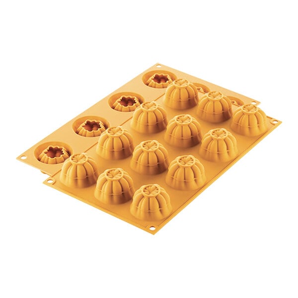 A yellow silicone mold with 12 tomato-shaped compartments.