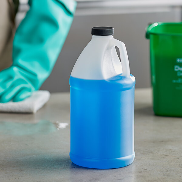 A translucent HDPE jug filled with blue liquid sitting on a counter.