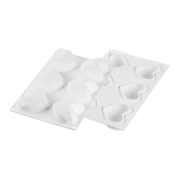 A white silicone baking mold with heart-shaped compartments.