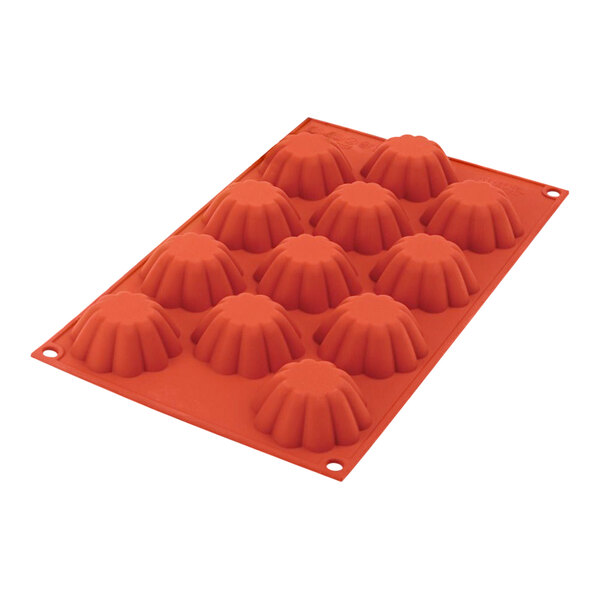 A red Silikomart silicone mold with 12 mini briochette cavities.