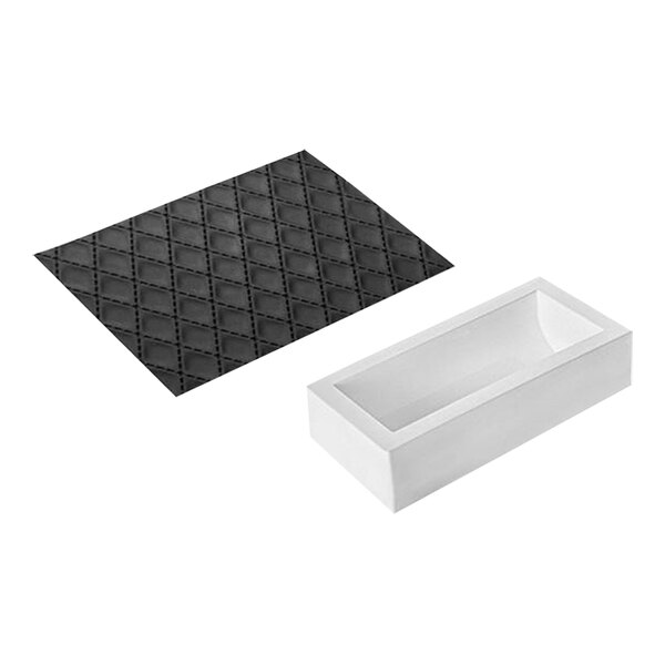 A white rectangular box with a clear window containing a black Silikomart mat with black stitching.