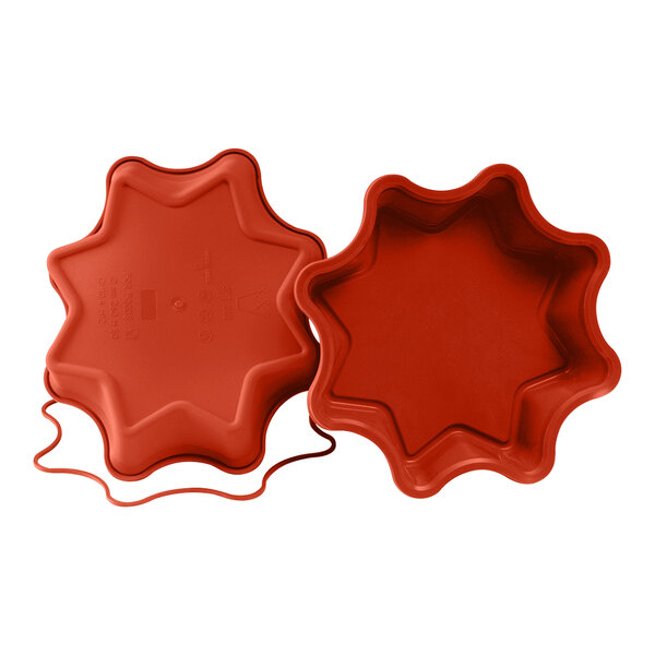 A red Silikomart star shaped silicone baking mold.