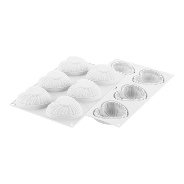 A white Silikomart silicone baking mold with six curved compartments.