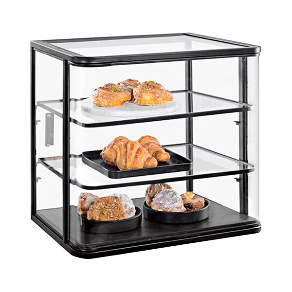 A Cal-Mil glass bakery display case filled with pastries.