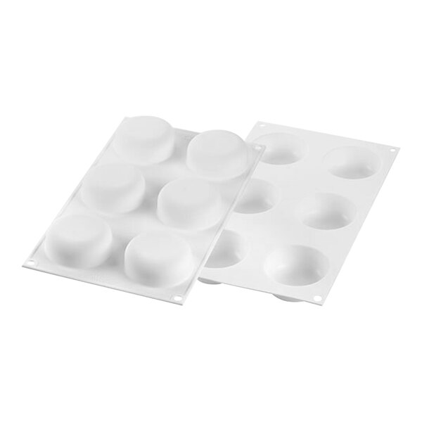 A white Silikomart silicone baking mold with 6 curved compartments.